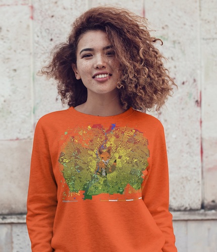 Woman wearing an orange sweatshirt showing a map of Leicester in the UK Midlands showing an image of a fox constructed from local buildings. 